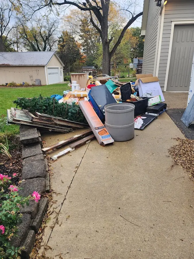 Dumpster being loaded with debris for Estate Cleanout Dumpster Rental in Rogersville